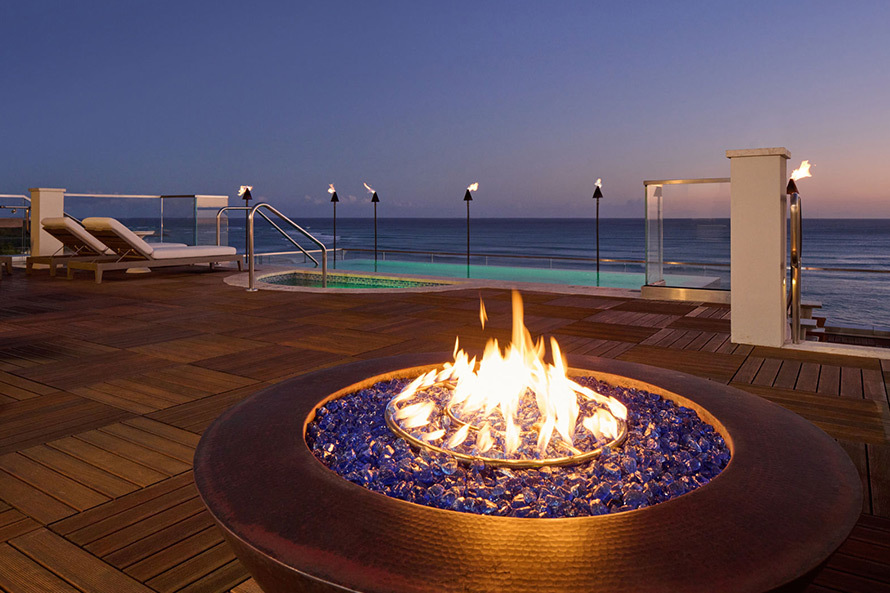Relax by the rooftop firepit as you enjoy the sunset over Waikiki Beach.