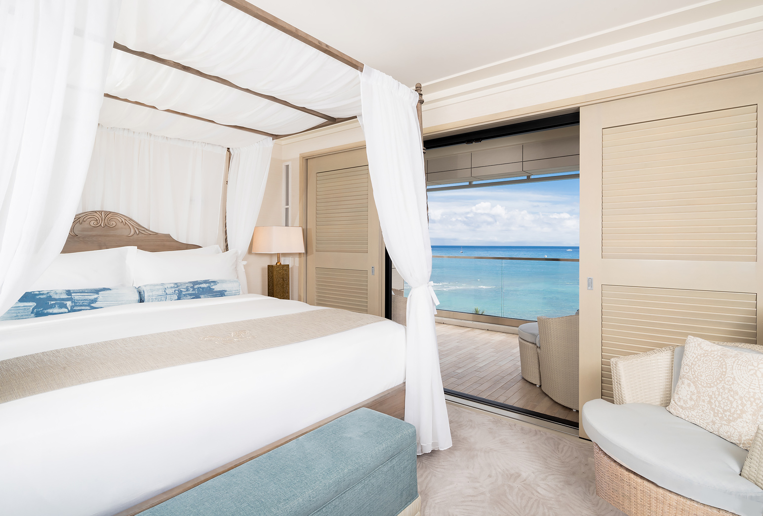 ESPACIO oceanfront master bedroom with four-poster bed and access to the balcony.