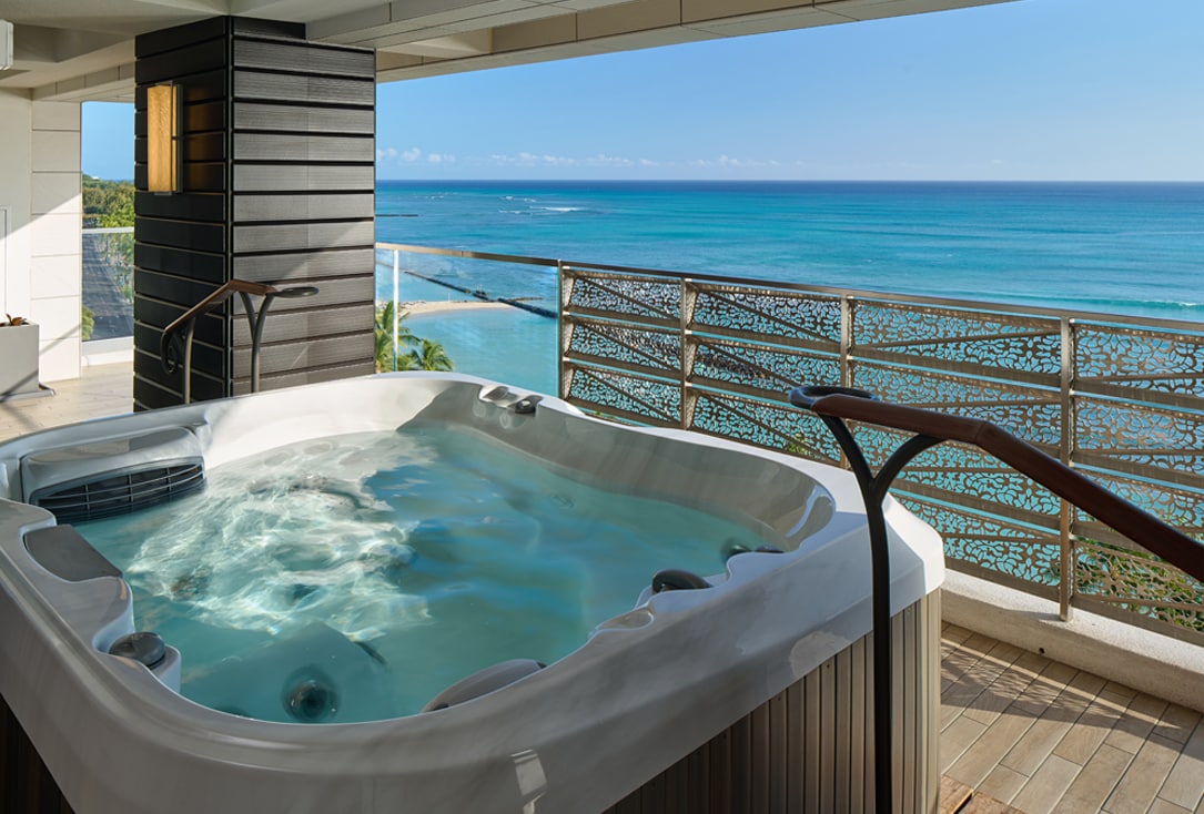 Jacuzzi on balcony with ocean views.