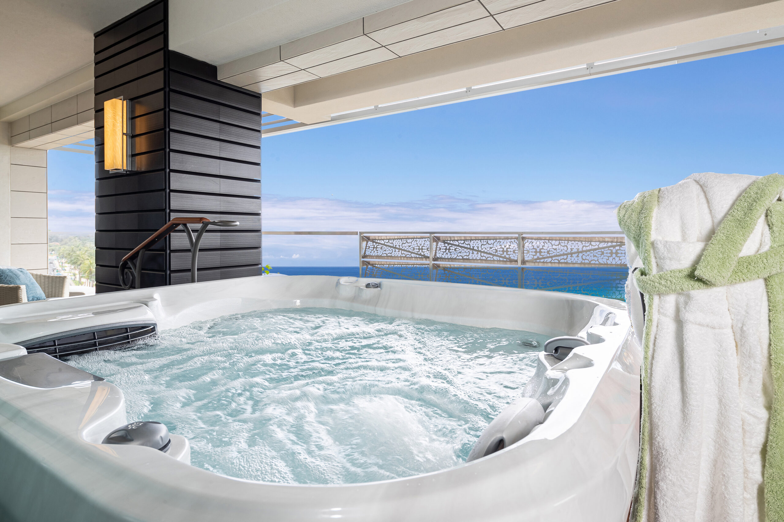 Jacuzzi on balcony with ocean view.