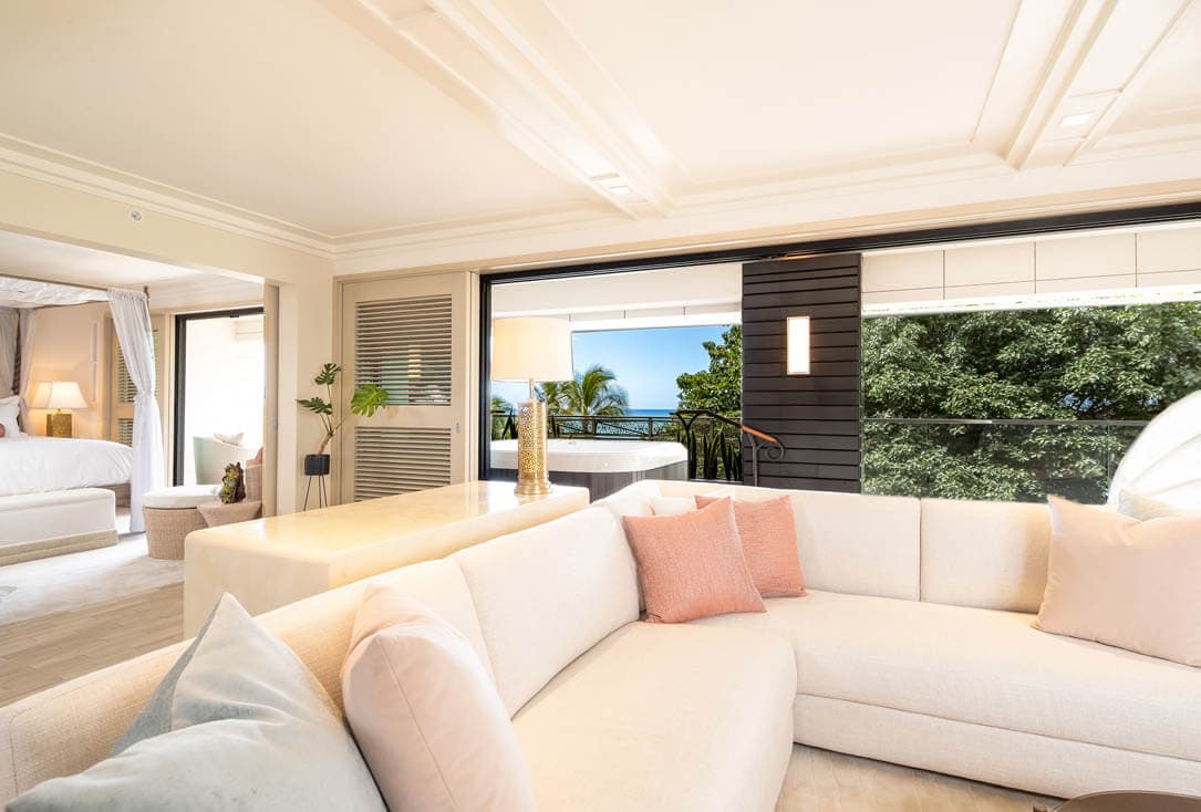 Living area couch and balcony with ocean view.